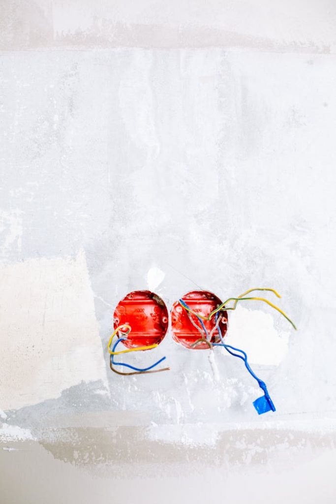 pexels-photo-3614757 Close-up of electrical wiring and sockets in a home renovation project.